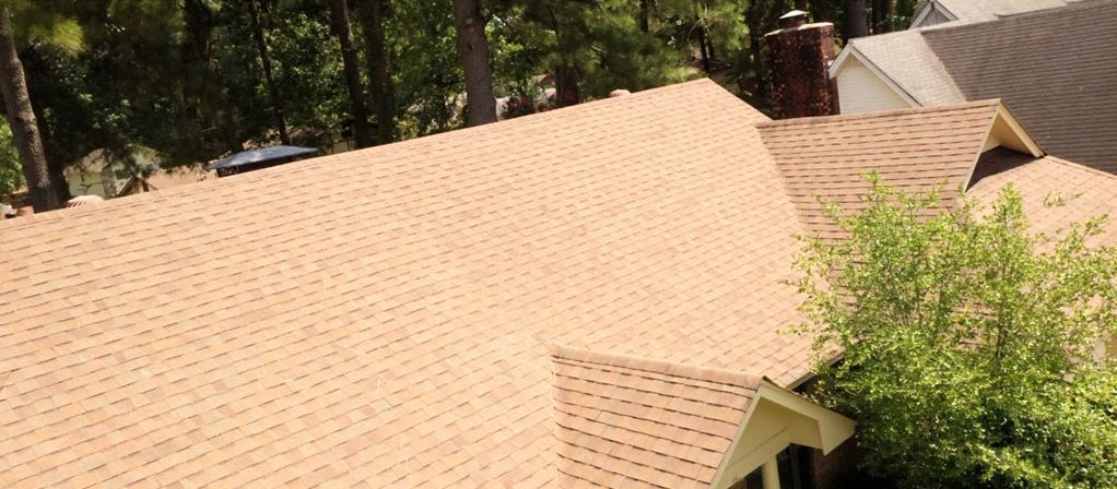 After: Roof covered in black algae streaks cleaned back to tan shingles in central Arkansas