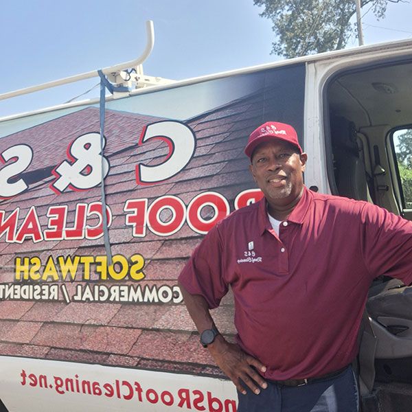 Charles Shelton, owner of C & S Roof Cleaning in Little Rock AR, beside his soft wash van