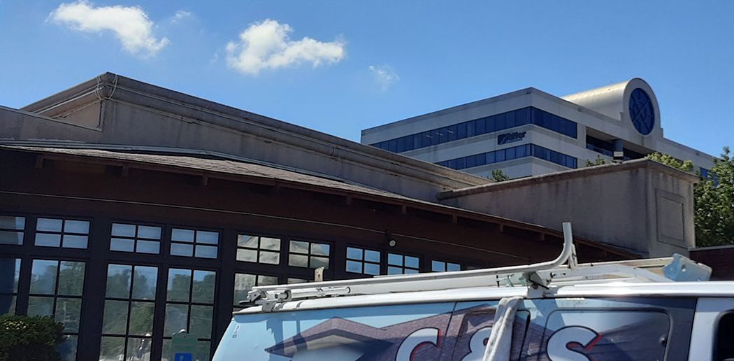 Before: Commercial building exterior and roof soft washed in the Little Rock area