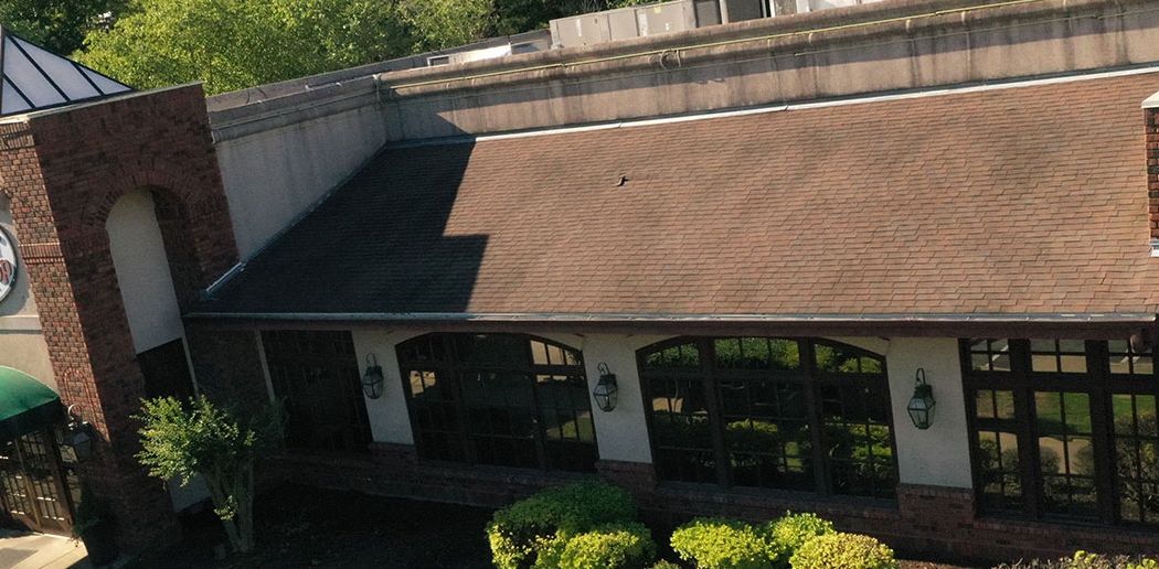Before: Office building roof line after commercial roof cleaning in the Little Rock area
