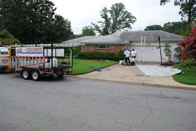 Work trailer and crew at a home during a house soft wash in Little Rock AR