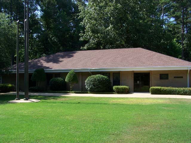 After: Ranch home with a low-slope roof cleaned of algae stains in central Arkansas
