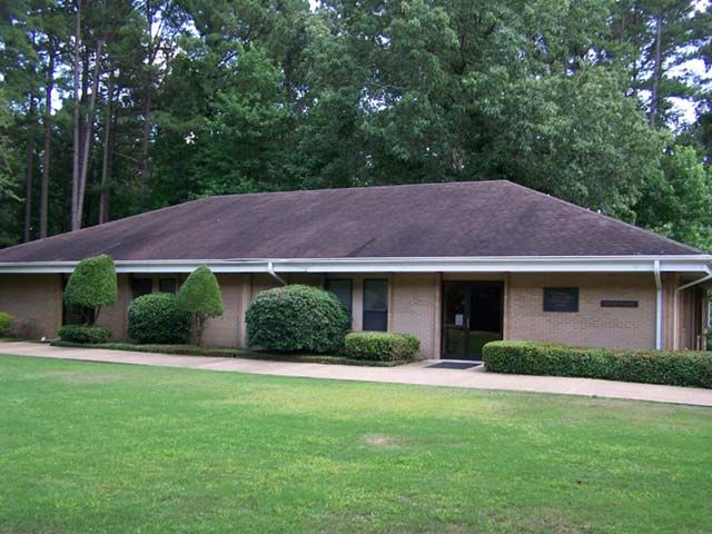 Before: Ranch home with a low-slope roof cleaned of algae stains in central Arkansas