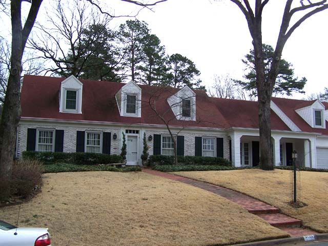 Before: Cape Cod home with a red roof soft washed clean in central Arkansas