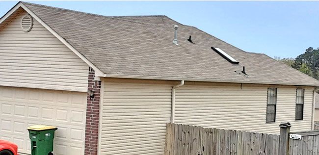 After: Siding and brick ranch home with a streaked roof cleaned in central Arkansas