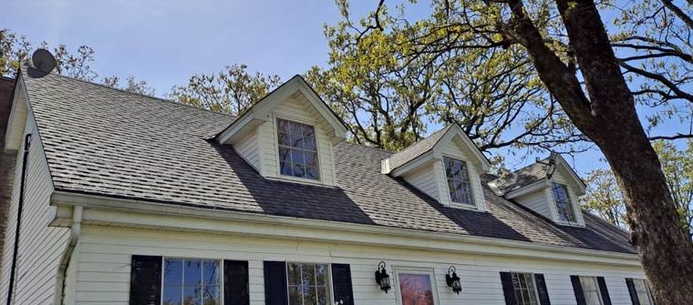After: Two-story home with a stained upper roof after roof cleaning in central Arkansas