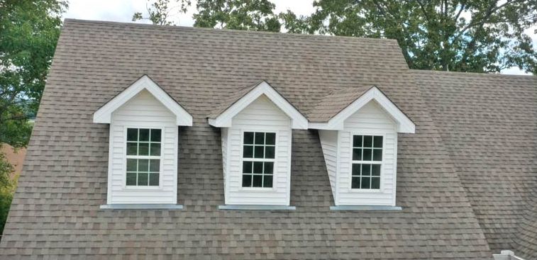 Before: Roof with white dormers cleaned of black streaks in central Arkansas