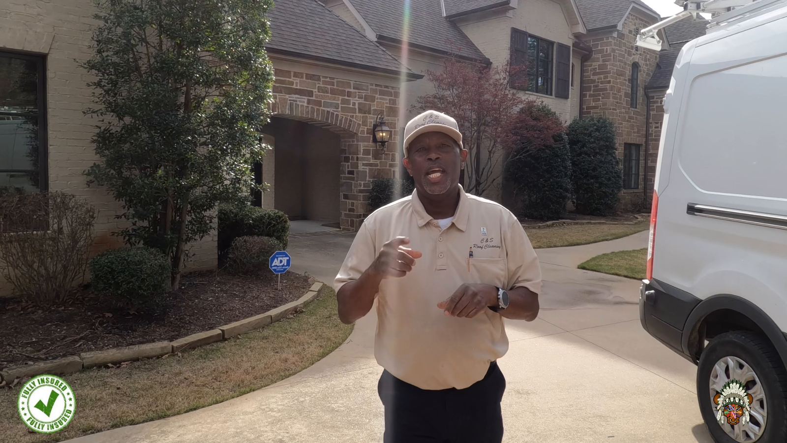 Charles Shelton of C & S Roof Cleaning at a stone home with a clean roof and gutters in Little Rock AR