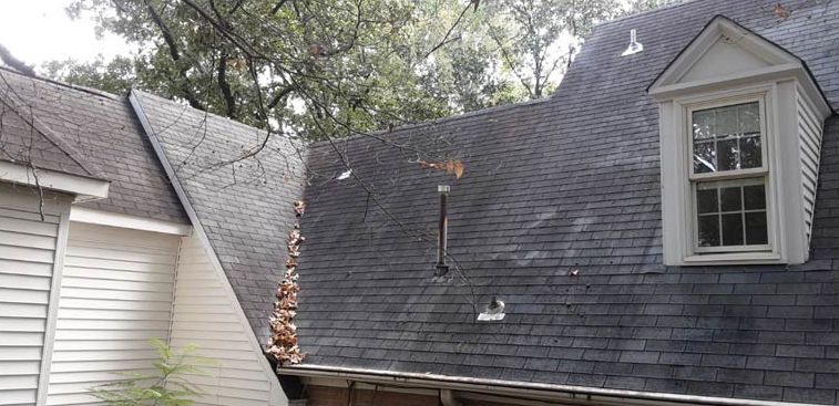 Before: Steep dormer roof with moss and algae removed by roof cleaning in the Little Rock AR area